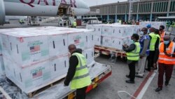 Airport officials receive boxes of Moderna coronavirus vaccine after their arrival at the airport in Nairobi, Kenya, Sept. 6, 2021. 