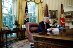 FILE - U.S. President Donald Trump is seen during a phone call at the Oval Office of the White House, in Washington, June 27, 2017.