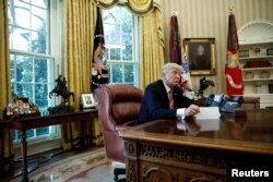 FILE - U.S. President Donald Trump is seen during a phone call at the Oval Office of the White House, in Washington, June 27, 2017.