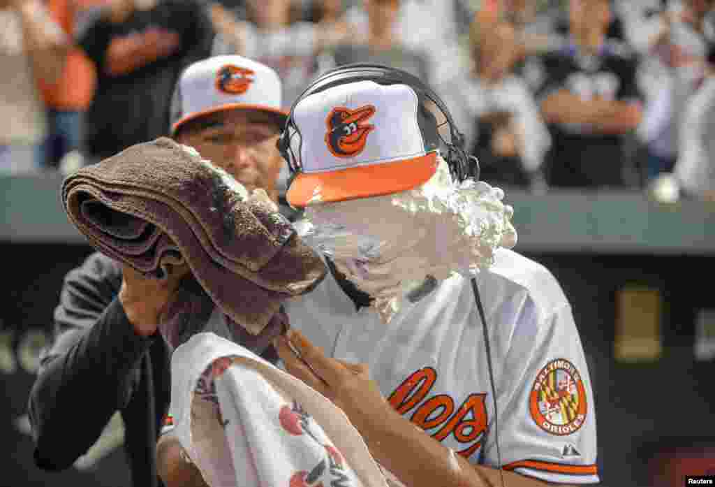 After getting his first major league base hit and his first major league home run against the Toronto Blue Jays, Baltimore Orioles second baseman Jonathan Schoop gets a shaving cream pie to the face from teammate Chris Dickers following their MLB American League baseball game in Baltimore, Maryland, USA, Sep. 25, 2013.