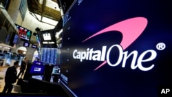 The logo for Capitol One Financial appears above a trading post on the floor of the New York Stock Exchange, July 30, 2019. 