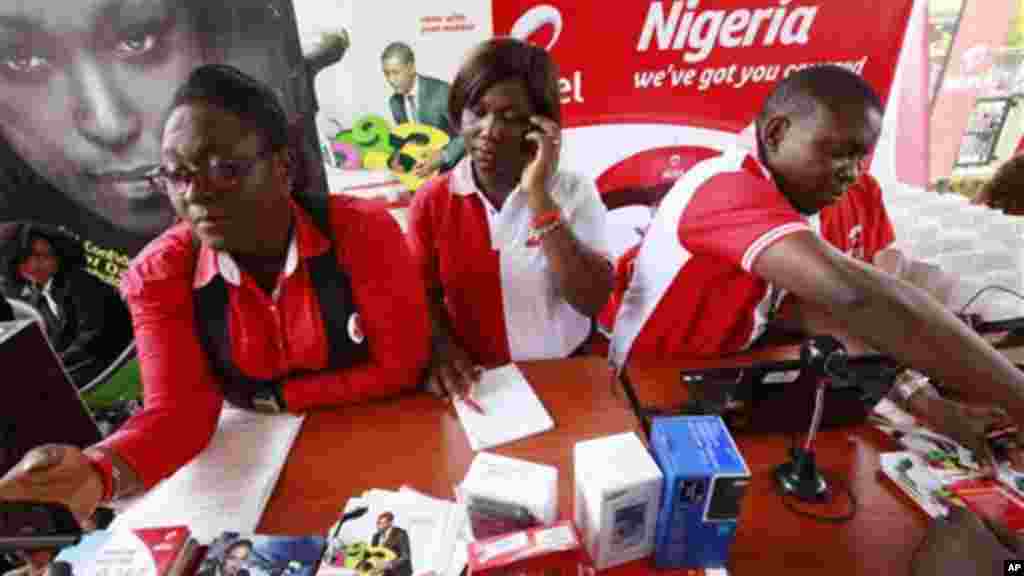 Staffs of Airtel attend to a customer during the launch of mobile number portability in Lagos, Nigeria, Monday, April 22, 2013.