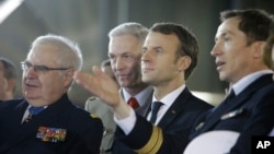 French President Emmanuel Macron (2nd-R), his personal military Chief of Staff, Admiral Bernard Rogel (L), the Chief of the Defense Staff of the French Army, Gen. Francois Lecointre (2nd-L) listen to Jean Porcher, ship's Captain of the Dixmude, docked in the French Navy base of Toulon, southern France, Jan. 19, 2018. 