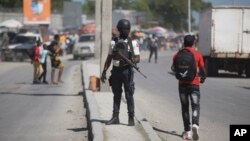 FILE - National police officers patrol an intersection in Port-au-Prince, Haiti, Aug. 5, 2023. Kenya has offered to send a police force to help combat gang violence in the Caribbean nation. 