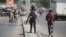 FILE - National police officers patrol an intersection in Port-au-Prince, Haiti, Aug. 5, 2023. Kenya has offered to send a police force to help combat gang violence in the Caribbean nation. 