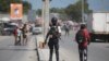 FILE - National police officers patrol an intersection in Port-au-Prince, Haiti, Aug. 5, 2023.