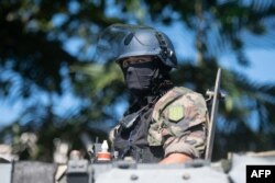 A security official looks on from an armored vehicle in Noumea, New Caledonia, on May 18, 2024.