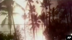 In this image from video, an explosion is seen from the ground during a fireworks show at the temple in Kollam, in the southern Indian state of Kerala, April 10, 2016.