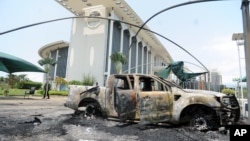 Burnt out cars are seen outside a government building, following an election protest in Libreville, Gabon, Sept. 1, 2016.