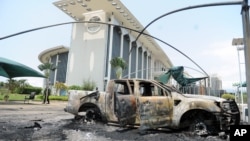 Burnt out cars are seen outside a government building, following an election protest in Libreville, Gabon, Sept. 1, 2016.