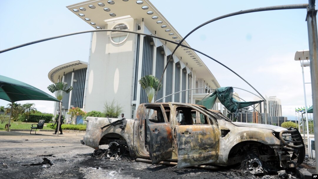 Burnt out cars are seen outside a government building, following an election protest in Libreville, Gabon, Sept. 1, 2016.