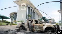 Burnt out cars are seen outside a government building, following an election protest in Libreville, Gabon, Sept. 1, 2016.