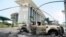 FILE - Burnt-out cars are seen outside a government building, following an election protest in Libreville, Gabon, Sept. 1, 2016.