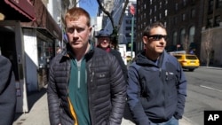 FILE - James Brady (l) and Andrew Rossig (r) two parachutists who jumped from One World Trade Center in September 2013, are accompanied by attorney Timothy Parlatore to surrender to police, in New York, March 24, 2014.
