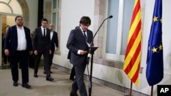 Catalonia regional President Carles Puigdemont arrives for a statement after signing the decree officially calling for the vote on a binding independence referendum, following a plenary session at the Parliament of Catalonia in Barcelona, Spain, Sept. 6, 2017.