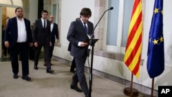 FILE - Catalonia regional President Carles Puigdemont arrives for a statement following a plenary session at the Parliament of Catalonia in Barcelona, Spain, Sept. 6, 2017.