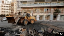 A bulldozer clears the rubble from a street after protests against the Lebanese government in Beirut, Oct. 19, 2019. The protests began after the government announced a slate of new proposed taxes, including a $6 monthly fee on Whatsapp voice calls. 