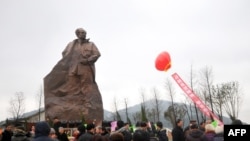 FILE - A statue of former Communist Party chief Hu Yaobang, a reformer whose death sparked the Tiananmen Square democracy protests, being unveiled in Taizhou, east China's Zhejiang province, Jan. 13, 2013.
