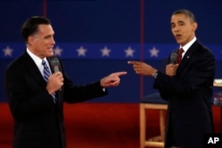 FILE - Republican presidential nominee Mitt Romney, left, and President Barack Obama spar during a presidential debate at Hofstra University in Hempstead, N.Y., Oct. 16, 2012.