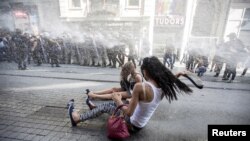 Riot police use a water cannon to disperse LGBT rights activist before a Gay Pride Parade in central Istanbul, Turkey, June 28, 2015. 