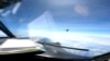 FILE - In this image from video provided by the U.S. Navy, a Chinese J-16 fighter flys aggressively close to a U.S. RC-135 aircraft flying in international airspace over the South China Sea on May 26, 2023. 