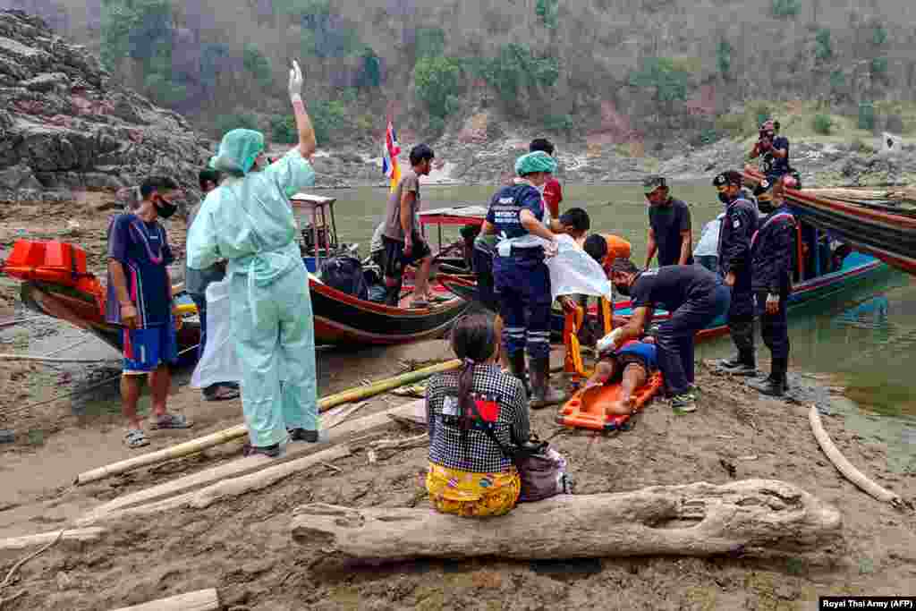 An injured Myanmar refugee is transported to a hospital in Mae Sam Lap, Thailand, after crossing the Salween river from the Myanmar side while while fleeing from airstrikes in Myanmar&#39;s eastern Karen state following the February military coup.&nbsp;