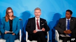 Copenhagen Mayor Frank Jensen, center, Children Investment Fund Foundation Chief Kate Hampton, left, and Seychelles President Danny Faure, right, addresses the Climate Action Summit in the United Nations General Assembly.