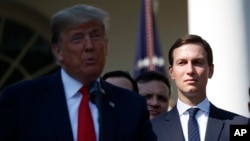 FILE - White House Senior Adviser Jared Kushner, right, listens as President Donald Trump, left, announces a revamped North American free trade deal, in the Rose Garden of the White House in Washington.