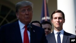 FILE - White House Senior Adviser Jared Kushner, right, listens as President Donald Trump, left, announces a revamped North American free trade deal, in the Rose Garden of the White House in Washington.