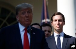 FILE - White House Senior Adviser Jared Kushner, right, listens as President Donald Trump, left, announces a revamped North American free trade deal, in the Rose Garden of the White House in Washington.