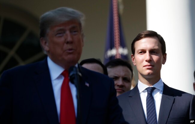 FILE - White House Senior Adviser Jared Kushner, right, listens as President Donald Trump, left, announces a revamped North American free trade deal, in the Rose Garden of the White House in Washington.