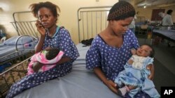 FILE - Women sit with their newborn babies in a ward of the Lagos Island Maternity Hospital in Lagos, Nigeria, Oct. 31, 2011.