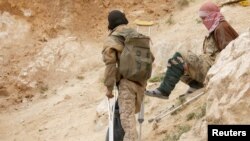Injured Islamic state militants are seen in the village of Baghouz, Deir Al Zor province, Syria, March 14, 2019.