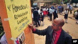 Ugandan anti-gay activist Pastor Martin Ssempa posts public notice offering "rehabilitation" for homosexuals, National Theater, Kampala, Feb. 25, 2014.