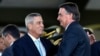 FILE - Brazilian President Jair Bolsonaro, right, greets his vice presidential candidate, Walter Souza Braga Netto during the celebration of Soldier's Day at the Army headquarters in Brasilia on Aug. 25, 2022.