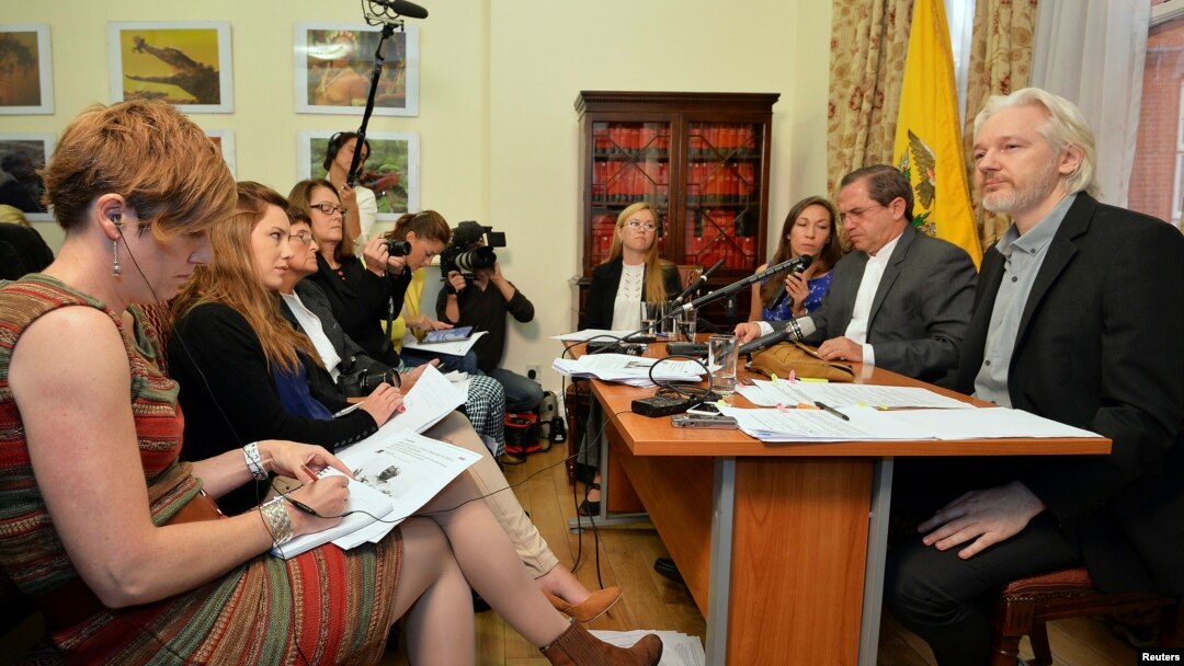 FILE - WikiLeaks founder Julian Assange, right, listens as Ecuador's Foreign Affairs Minister Ricardo Patino, second right, speaks, during a news conference at the Ecuadorian embassy in central London, Aug. 18, 2014. 