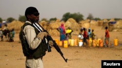 FILE - A Nigerien soldier stands guard in a camp in the city of Diffa following attacks by Boko Haram fighters in Niger's Diffa region, June 18, 2016.