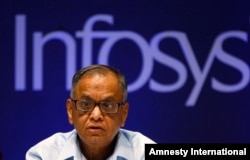 FILE- In this June 15, 2013 file photo, Infosys Executive Chairman N. R. Narayana Murthy reacts to a shareholders comment during the company's 32th Annual General Meeting in Bangalore, India. In 2013 Infosys was accused of bringing thousands of foreign workers to the United States using incorrect visas.