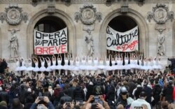 Paris Opera dancers perform in front of the Palais Garnier against the French government's plan to overhaul the country's retirement system, in Paris, France, Dec. 24, 2019.