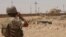 An Iraqi soldier monitors the Iraq-Syria border point, Abu Kamal, July 22, 2012.