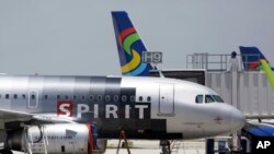 FILE - A Spirit Airlines airplane sits on the tarmac at Fort Lauderdale-Hollywood International Airport in Fort Lauderdale, Florida.