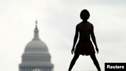 With the dome of the U.S. Capitol in the background, a homeless man named Damu stretches on the National Mall in Washington.