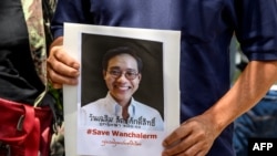 A protester holds a portrait of allegedly kidnapped Thai activist Wanchalearm Satsaksit outside the Embassy of Cambodia in Bangkok on June 8, 2020.