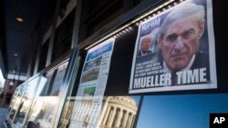 Newspaper front pages from around the nation are on display at the Newseum, March 23, 2019, in Washington. Special counsel Robert Mueller closed his Russia investigation with no new charges, ending the probe that has cast a shadow over Donald Trump's presidency.