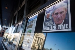 FILE - Newspaper front pages from around the nation are on display at the Newseum, March 23, 2019, in Washington. Special counsel Robert Mueller closed his Russia investigation with no new charges.