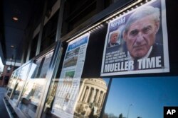 FILE - Newspaper front pages from around the nation are on display at the Newseum, March 23, 2019, in Washington. Special counsel Robert Mueller closed his Russia investigation with no new charges.