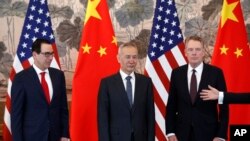 FILE - Chinese Vice Premier Liu He, center, U.S. Treasury Secretary Steven Mnuchin, left, and U.S. Trade Representative Robert Lighthizer, right, arrive for a group photo session after concluding their meeting in Beijing, May 1, 2019.