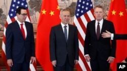 Chinese Vice Premier Liu He, center, U.S. Treasury Secretary Steven Mnuchin, left, and U.S. Trade Representative Robert Lighthizer, right, arrive for a group photo session after concluding their meeting in Beijing, May 1, 2019.