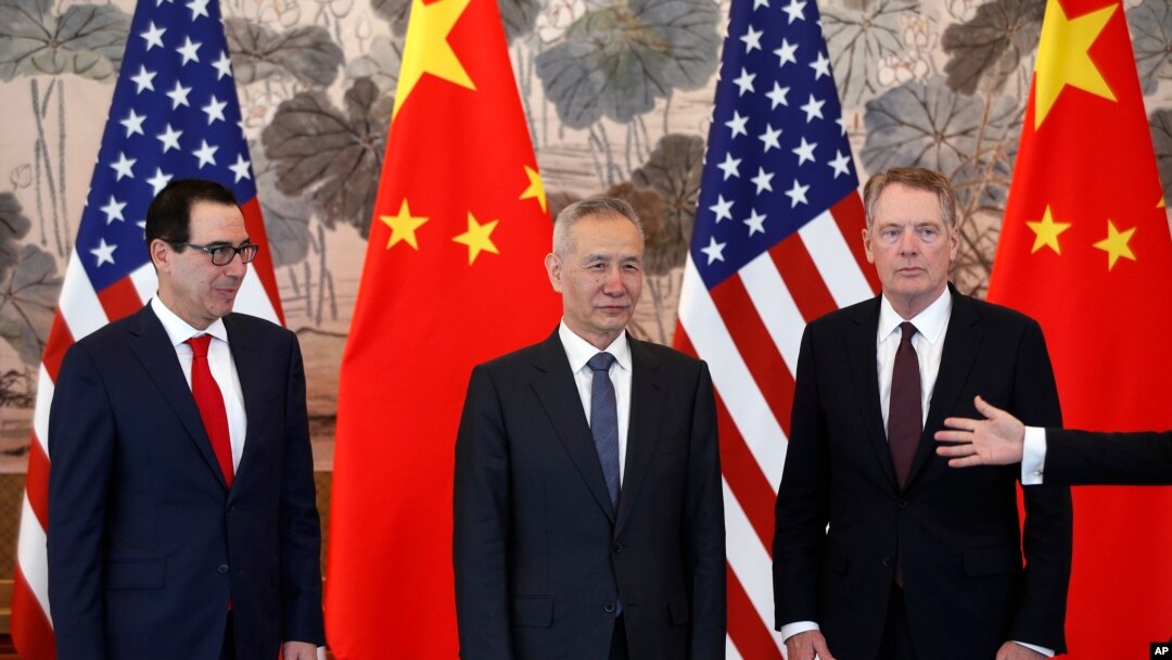 FILE - Chinese Vice Premier Liu He, center, U.S. Treasury Secretary Steven Mnuchin, left, and U.S. Trade Representative Robert Lighthizer, right, arrive for a group photo session after concluding their meeting in Beijing, May 1, 2019.