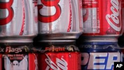 Cans of Coca-Cola and Pepsi share space on a vendor's cart Thursday, Oct. 19, 2006 in New York. The Coca-Cola Co. reported a 14 percent jump in third-quarter profit Thursday, aided by sales gains in Europe tied to World Cup soccer promotions and growth in